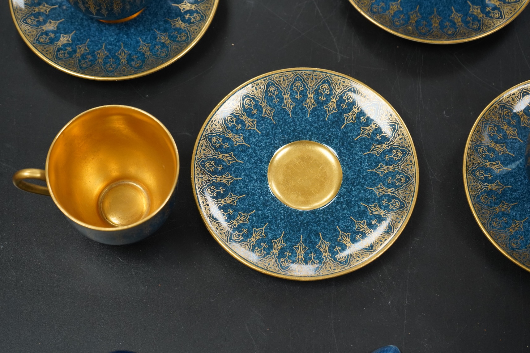 A set of six Royal Worcester cups and saucers, powder blue and gilt decoration, together with a set of six silver and enamel teaspoons